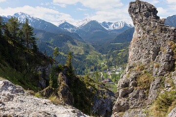 A scenic mountain landscape with snow-capped peaks, green valleys, and rocky outcrops in Zakopane - Lesser Poland - Poland