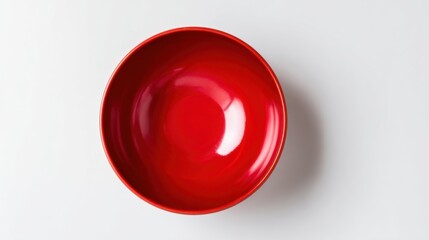 Empty Red Bowl with Reflection on White Surface Perfect for Food and Serving Themes.