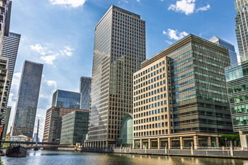 Canary Wharf London waterfront skyline with modern glass office towers © SellStock