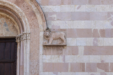 Facade and portal over entrance gate to of Basilica of Saint Clare, gothic roman catholic church, Assisi, Italy