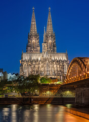 Cologne, Germany – April 25, 2025: Cologne Cathedral and Hohenzollern Bridge at Blue Hour,...