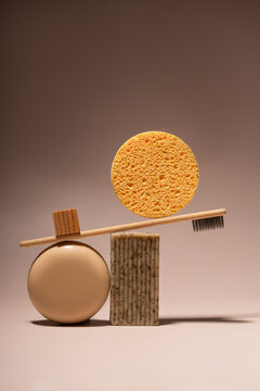 Bamboo toothbrush and toiletries on a neutral background