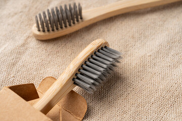Bamboo toothbrushes on natural fabric background