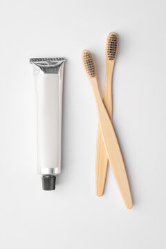 Bamboo toothbrushes with toiletries on white background
