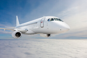 White passenger jetliner fly in the air above the clouds