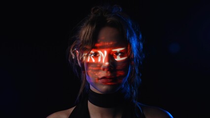 Portrait of a woman with a projection of the inscription Warning on her face