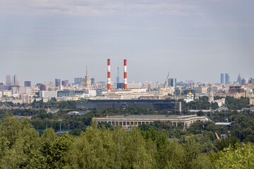 The urban landscape from Moscow's Vorobyovy Gory with the red and white pipes of the TPP-12 power plant on Berezkova Embankment