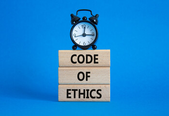 Code of ethics symbol. Concept words Code of ethics on wooden blocks with alarm clock. Beautiful...