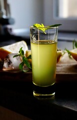 Glass of fresh homemade lemonade with lemon slices, mint, and ice cubes. Refreshing summer drink perfect for healthy lifestyle, detox, or beverage themes.