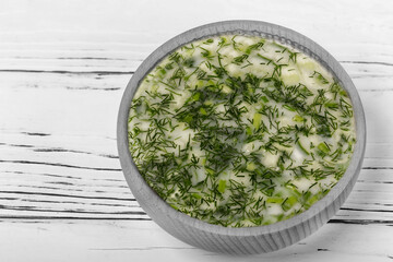 Okroshka - cold summer soup in a bowl close-up