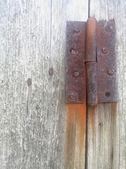 rusty hinge on old wooden door. rust chronicle
