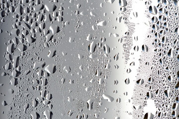 background, unusual, abstract. drops of morning dew, condensation on the glass. wet glass. water drops close-up. beautiful background for text. Spray cool condensate water on the glas