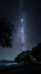 Midnight summer beach landscape with the milky way over tranquil waters Generative AI