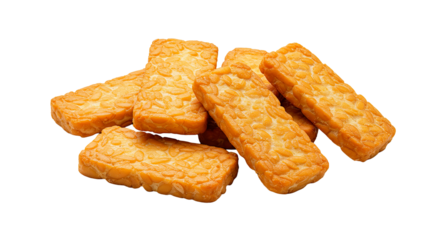 A pile of rectangular shaped tempeh pieces with visible soybean texture on a black background food photography