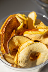 Macro shot of dried apple and pear slices in cup