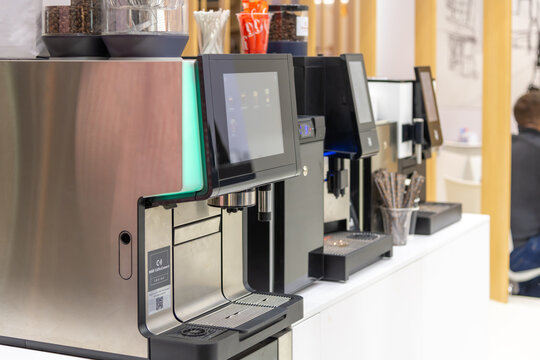 Russia, Moscow - October 07, 2021: Multiple WMF coffee vending machines are lined up in a contemporary setting. Customers can easily select their drinks using touch screens. Illustrative editorial.