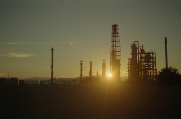oil refinery at sunset