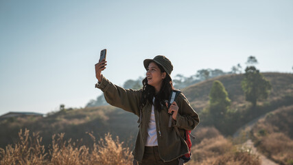 A couple is hiking along a forest trail on a beautiful day, enjoying nature and their outdoor adventure perfect for themes of travel, hiking, and togetherness. © NewSaetiew
