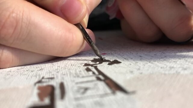 Person is drawing a picture with a brush