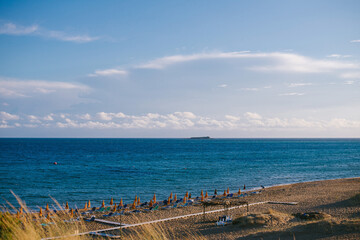 Fototapeta premium Serene Beach with Sun Loungers and Umbrellas
