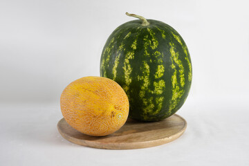 Melon and watermelon on a wooden tray