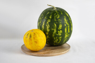 Melon and watermelon on a wooden tray