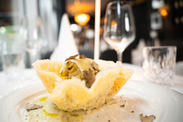 Truffle pasta in parmesan basket – gourmet close-up