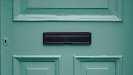 Elegant wooden english door with decorative mail slot and charming texture