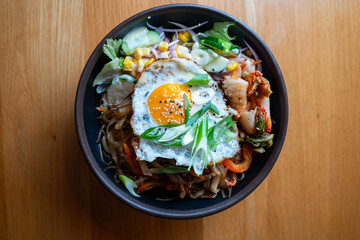 Bibimbap bowl with fried egg – top view