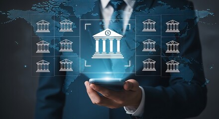 Businessman manages global banking network with mobile technology showing bank icons on a world map for financial transactions.