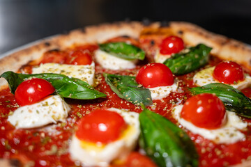Margherita pizza with cherry tomatoes – close-up