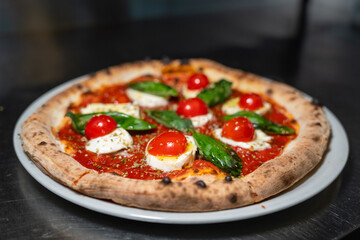 Margherita pizza with cherry tomatoes – front view