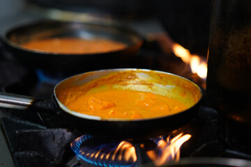Chicken curry in pan – cooking on gas stove