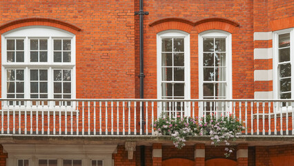 Naklejka premium Old red brick English house with traditional architecture and rustic countryside feel