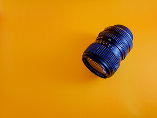 Close-Up of a Vintage Zoom Camera Lens on yellow Background