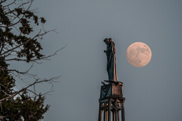 Our Lady of the Ark of the Covenant Church in Abu Ghosh sculpture during a full moon rising and lighting the statue from the back