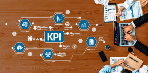 A team collaborates during a strategic meeting, highlighting key performance indicators and data analysis to align their business objectives and drive success. Amity