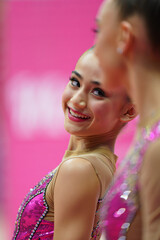 Joyful Gymnast Smiling During a Performance at an Indoor Gymnastics Event