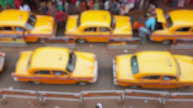Bokeh view of taxi stand near the Howrah railway station in Calcutta, India. Blurred background footage.