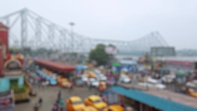 Bokeh view of road traffic at the streets of Kolkata near the Howrah railway station in Calcutta, India. Blurred background footage.