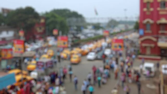 Bokeh view of road traffic at the streets of Kolkata near the Howrah railway station in Calcutta, India. Blurred background footage.