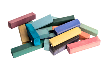 a pile of colored chalk sticks on a white surface