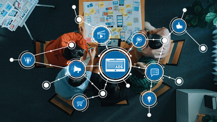 A diverse team engages in a collaborative advertising strategy session, utilizing digital tools and...