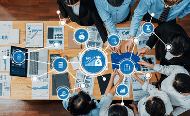 Professional team collaborates over financial reports and strategies, focusing on tax management...
