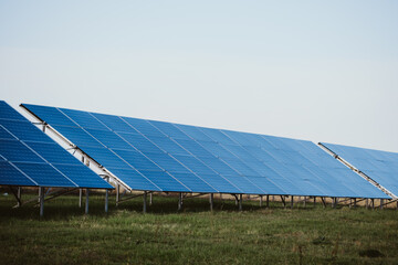 Solar Panels Farm in Rural Setting Under a Clear Sky Generating Clean Energy