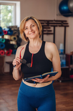 Woman personal trainer organizing her gym schedule