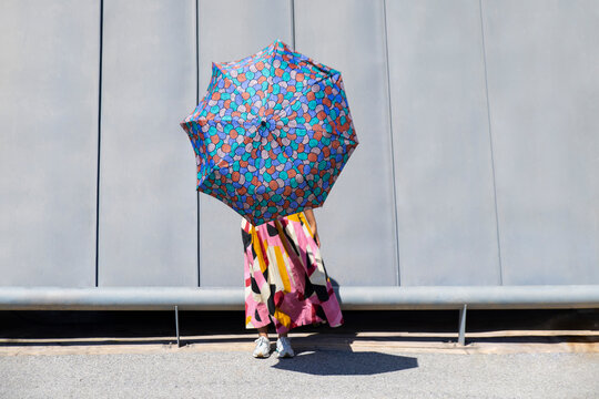Vibrant umbrella against modern architectural backdrop