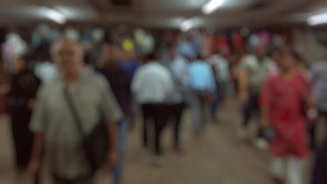 Bokeh view of passengers at Howrah railway station in Calcutta, India. Blurred background footage.