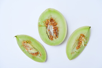 three pieces of melon on a white background flat lay