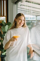 Young woman enjoying a refreshing cocktail in a cafe